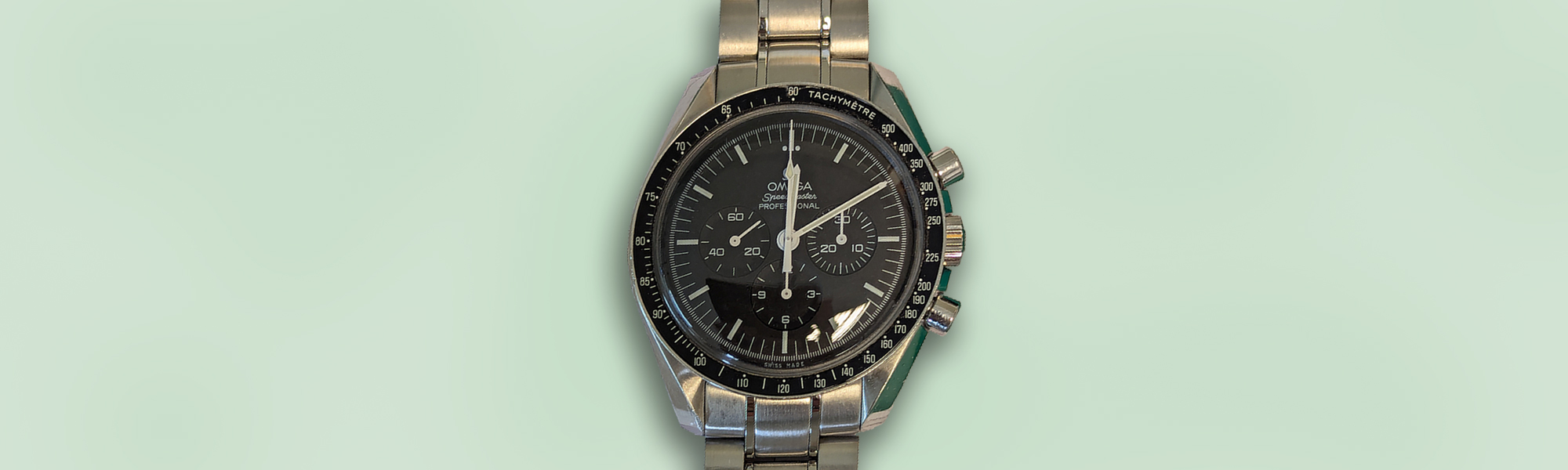 Omega Speedmaster watch on a green background banner